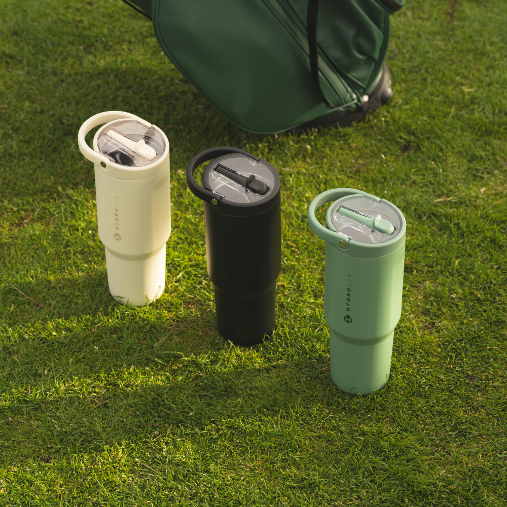 Tradeons Sport Bottles in Cream, Black, and Sage on Grass