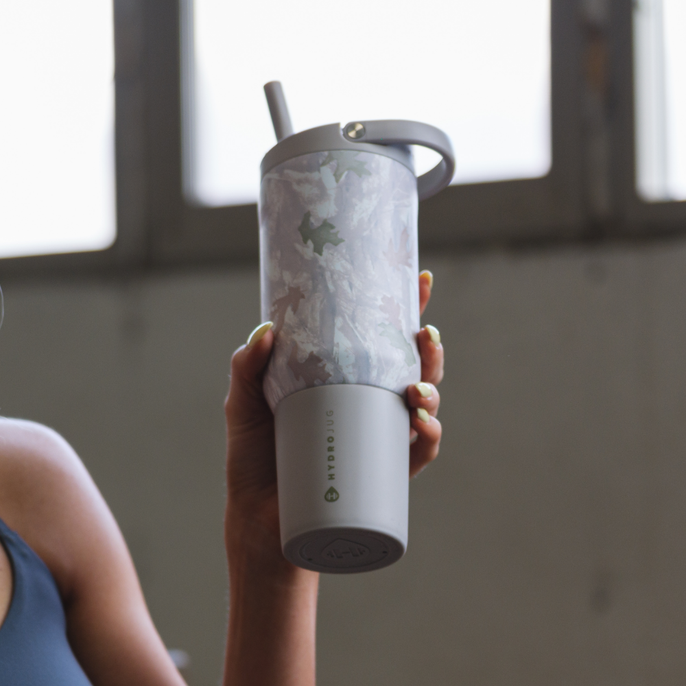 Person Holding Tradeons Camo Sport Bottle 20oz