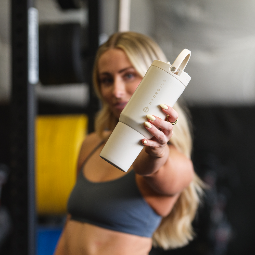 Person Holding Tradeons Cream Sport Bottle 20oz