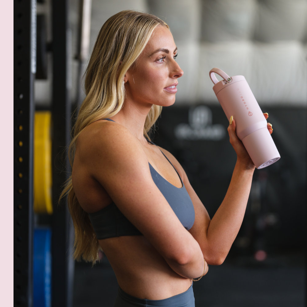 Woman Holding Tradeons Pink Sand Sport Bottle 20oz