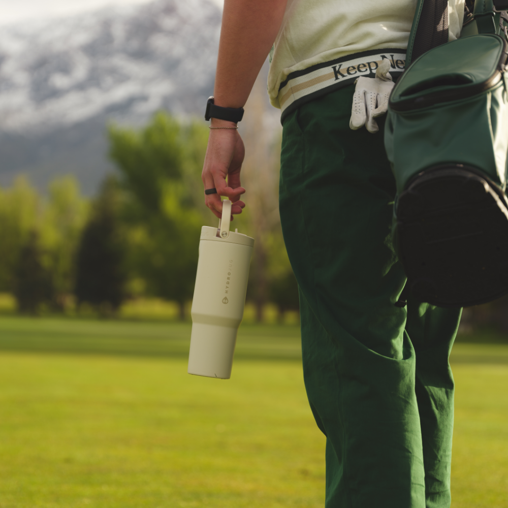 Person Holding Tradeons  Cream Sport Bottle 40oz
