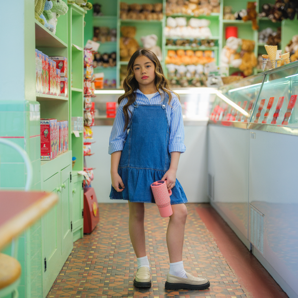 Girl Holding Tradeons Daisy Checkers Traveler 20oz